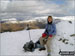 Sitting on Dove Crag summit cairn in the snow