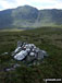 Foel Hafod-fynydd summit cairn with Aran Fawddwy looming beyond