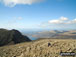 Lone fell walker on Scafell Pike with Symonds Knott and Sca Fell (left), Wast Water and Seatallen (right) beyond