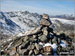 Snow on Black Sails summit cairn with Great Carrs (centre left) and Scafell Pike (far right) in the background