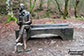 Statue to Robert Burns sitting on a bench in the Birks of Aberfeldy