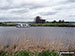 Boat on the River Bure with St Benet's Abbey Drainage Mill on the other side