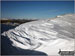 Snow scultured by the wind with the The Lawers range in the distance from Ben Ledi