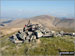 Pikethaw Hill summit cairn with Wisp Hill (Teviothead) beyond