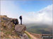 My partner Steve Bradbury on the summit of Mount Famine just as the mist lifted giving a glorious sunny day