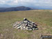 Y Llethr summit cairn with Rhinog Fawr in the distance