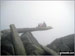 Hubby and kids, YingLi and WingHoi, on the cantilever rock on Glyder Fach in the mist