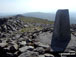 Pen Pumlumon Fawr (Plynlimon) summit trig point with Y Garn (Pumlumon) in the distance