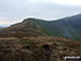 The unmarked grassy summit of Drysgol (Aran Fawddwy) with Drws Bach (centre left) and the upper lopes of Aran Fawddwy (right) in the distance