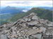 Ben Vane summit cairn with Beinn Narnain beyond and Ben Lomond and Ptarmigan in the distance across Loch Lomond