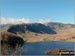 The Rigg (bottom left), Rough Crag (Riggindale) and High Street with a touch of snow on it across Haweswater Reservoir from near Rowantreethwaite Beck on Mardale Banks