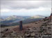 Post marking the pint where the Watkin Path joins Snowdon (Yr Wyddfa)'s South ridge above Bwlch Main - with Mynydd Mawrm Llyn Cwellyn and Moel Eilio in the distance